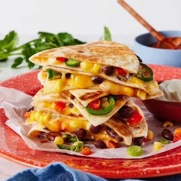 Cheese quesadilla with peppers, beans, and jalapeños