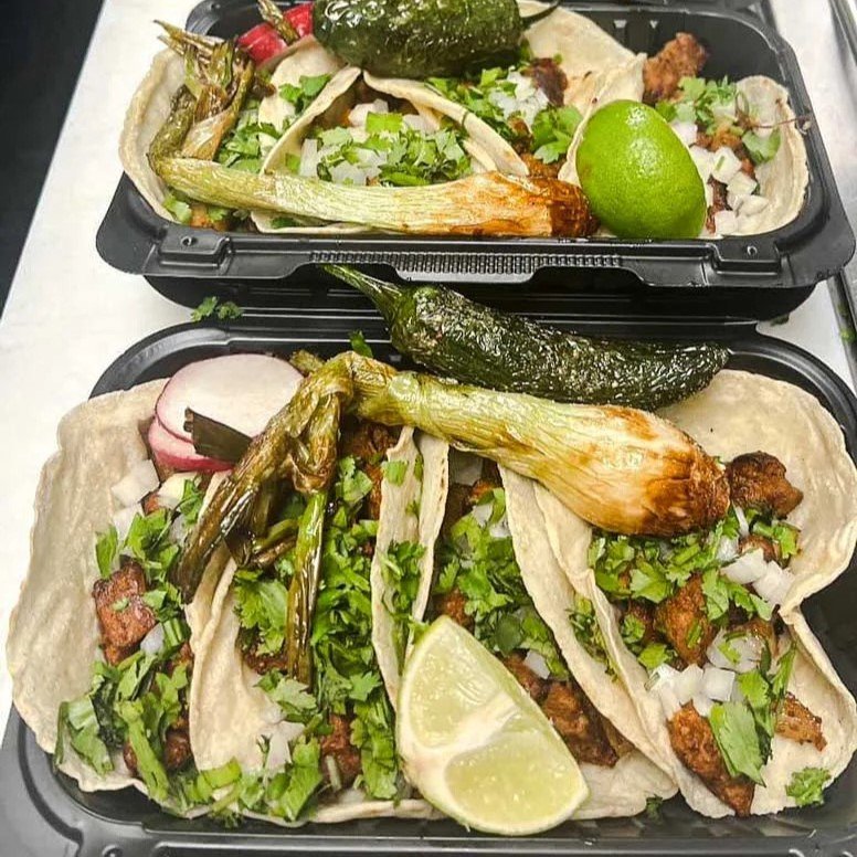 Mexican tacos with cilantro, onions, lime, and grilled peppers