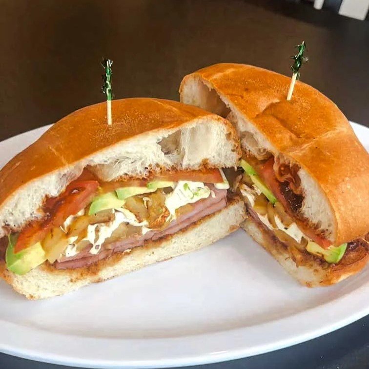 Mexican torta sandwich with ham, avocado, tomato, and cheese